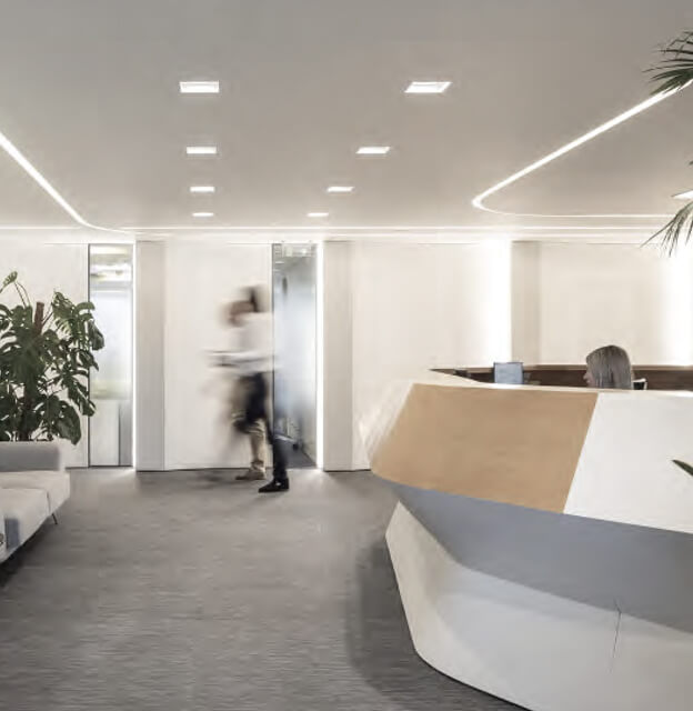 Win Medica office reception area with people walking through a bright, modern interior